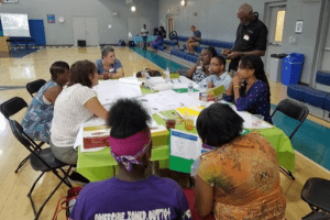 Picture of students working with community members in a community center