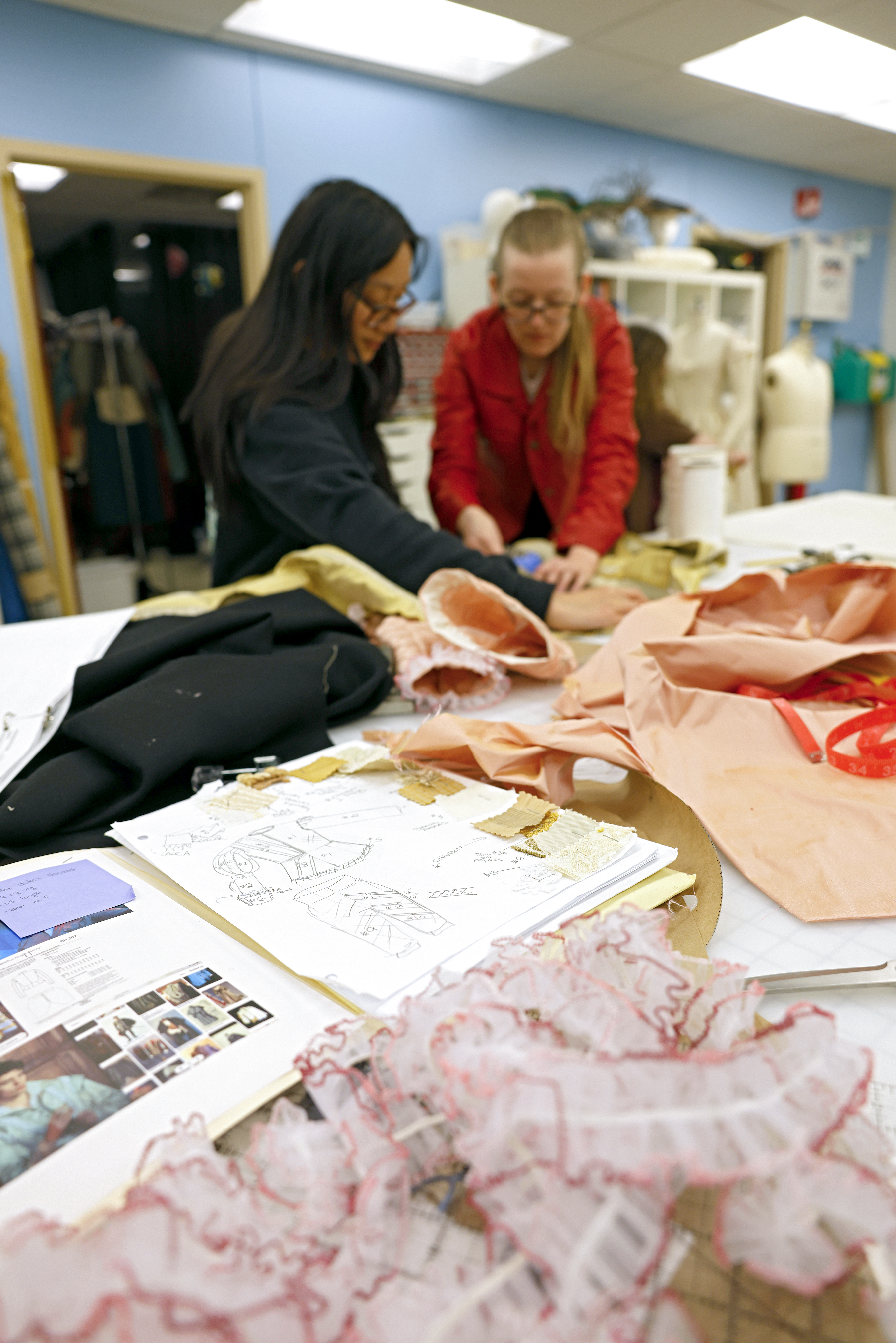 students working in the costume shop