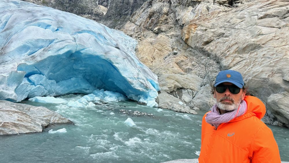 Marek in front of water and icebergs