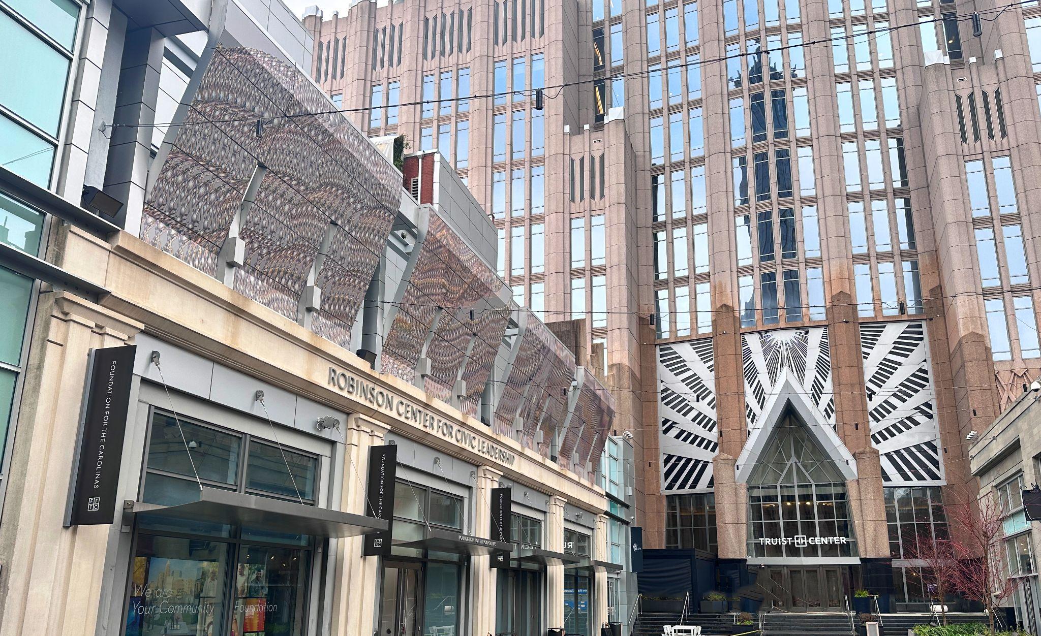Interwoven, a printed mural, hangs over the Truist Plaza.